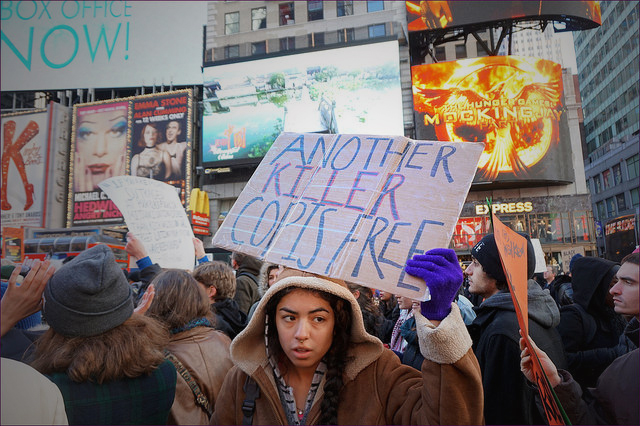A protester at the NYC action in solidarity with Ferguson. Mo, encouraging a boycott of Black Friday Consumerism. (Photo: The All-Nite Images)