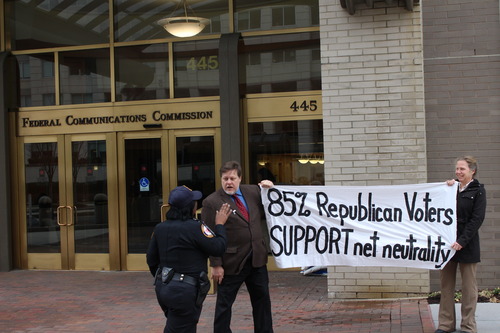 FCC security continued to harass the activists even once they were outside on a public sidewalk.