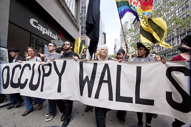 NEW YORK - MAY 1: Protesters march past a Capital One bank on their way to Union Square from Bryant Park during Occupy Wall St 'May Day' protests on May 1, 2012 in New York, NY. (Photo via Shutterstock)