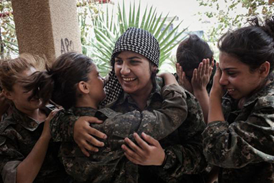 Kurdish YPJ fighters celebrate a victory. (Photo: Erin Trieb)