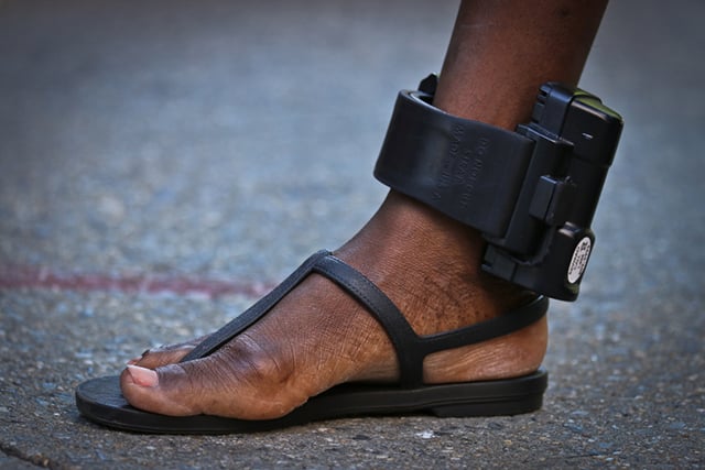 Garífuna woman with GPS ankle monitor. The device must be worn 24 hours a day. (Photo: Cinthya Santos Briones)