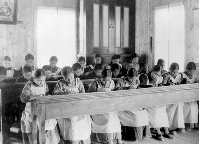 In a photo taken around 1936, Aboriginal Canadians attend a school at Fort Resolution in the Northwest Territories. Canada's Truth and Reconciliation Commission has concluded that the country's former policy of removing Aboriginal children from families for schooling could be best described as cultural genocide. In the US, Native children were subjected to similar policies for more than a century. (Photo: Library and Archives Canada) 