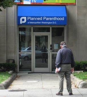 A protester stands outside a Planned Parenthood office.