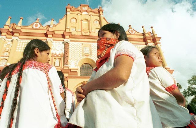 Zapatista women standing outside a cathedral. 