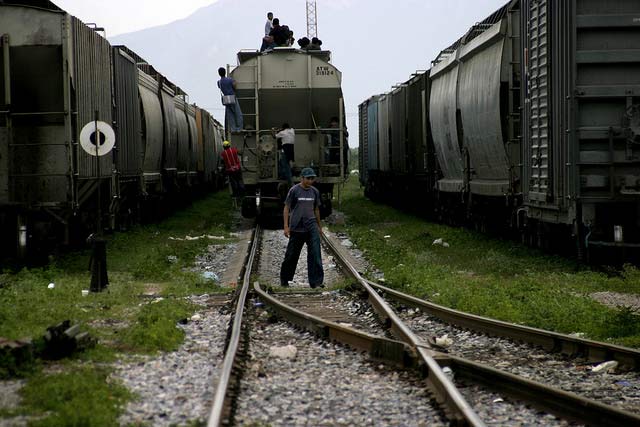 Central American migrants wait to board a freight train in Ixtepec, Mexico. The train, known as The Beast, will bring them to the US/Mexican border.
