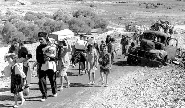 Palestinian refugees leave Galilee during the British Mandate of Palestine, 1948. (Photo: Fred Csasznik)