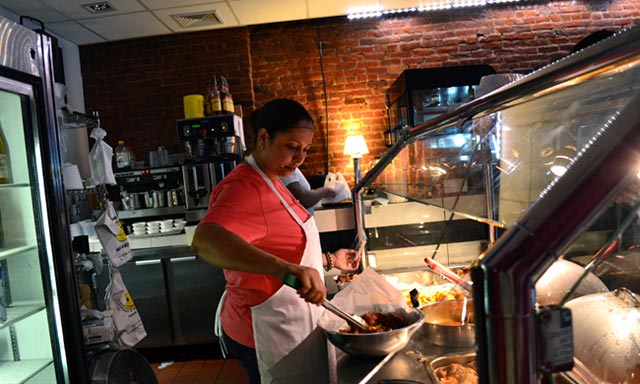 Rossy Caba works in her restaurant. (Photo: Abigail Savitch-Lew)