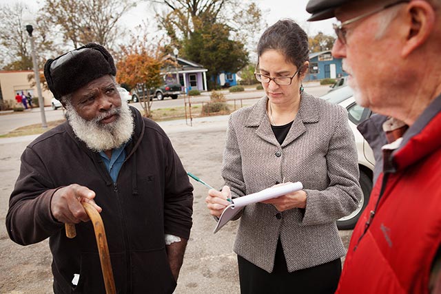 Attorney Engelman Lado, center, and Episcopal Reverend Tom Brown, right, speak with A.C. Brown in downtown Uniontown, AL. Engelman Lado interviewed local residents, including Brown, about coal ash pollution as part of an ongoing Title VI case.