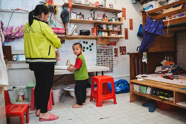 Ivy Gao with her daughter Sophia, 4 months, and her son Sampson, 3, in their unit in a Chinatown single-room occupancy hotel. (Photo: Tudor Stanley)
