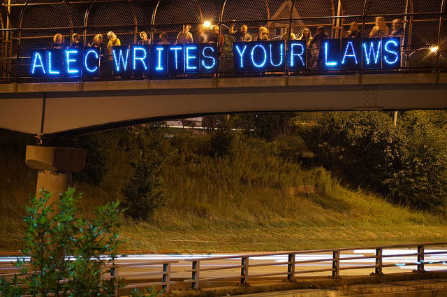 Activists display a sign on a Midwestern overpass on July 4th, 2012. (Photo: Light Brigading)