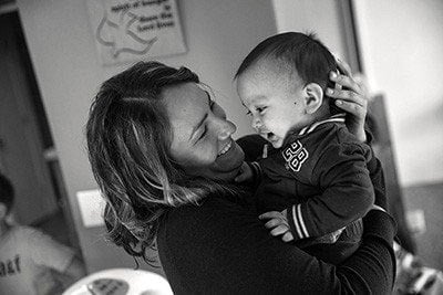Angelica Gonzalez hold her son, a toddler, in November 2015 at the house where they are living on the Olympic Peninsula in Washington state. (Photo: Mike Kane for Equal Voice News)