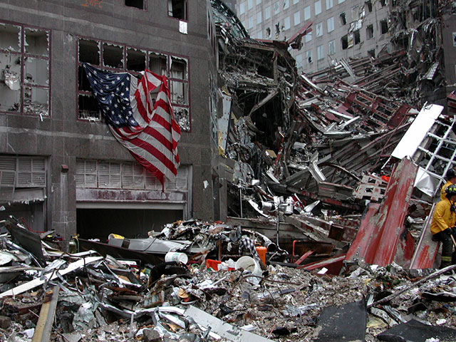 A US flag is draped on building across the street from Ground Zero World Trade Center in New York City on September 20, 2001. (Photo via SHutterstock)