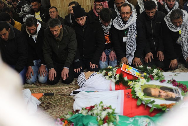 January 2: Funeral prayers are conducted at Al Hussein Mosque. (Photo: Christian Peacemaker Teams) 