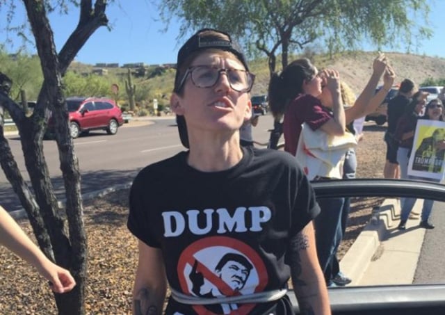 Ben Laughlin, an organizer with Puente Arizona, at the March 19 protest blocking the road to Trump’s rally. (WNV / Caitlin Breedlove)