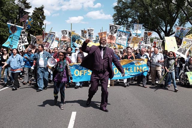 Gulf Coast environmental justice advocates Yudith Azareth Nieto and Hilton Kelly lead a march in Washington DC against offshore oil drilling on May 15. About 1,300 people attended the protest, which was part of a global week of action against fossil fuel extraction. (Sabelo Narasimhan)