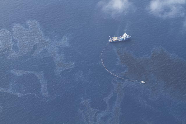 Boats skim oil and water off the surface of the Gulf of Mexico on May 14. A undersea oil pipeline connecting to a well to an offshore platform operated by Shell Oil discharged 88,000 gallons of oil into the Gulf last week.