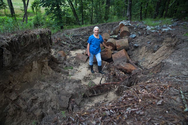 Eleanor Fairchild standing in a cut on her land caused by erosion connected to the Keystone Gulf Coast pipeline. TransCanada has agreed to fix the damage. (Photo: ©2016 Julie Dermansky)