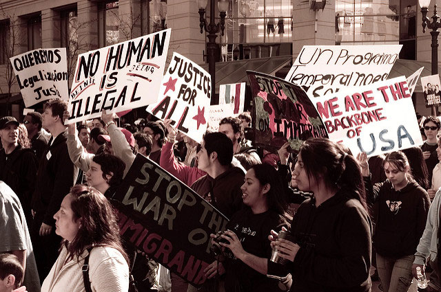 Activists display signs at an immigration reform rally in Portland, Oregon, on March 4, 2006. (Photo: Sam Grover)