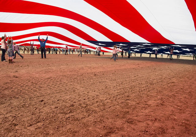 Members of the US military and the local community unravel the US flag at Frontier Park during a Military Monday event in Cheyenne, Wyo., July 25, 2016. From its founding the United States has been a nation made by wars.