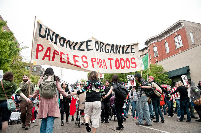 Activists gather around a sign during a May Day march in Chicago, Illinois, May 1, 2012. (Photo: Sarah Ji)