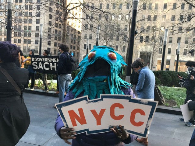 An activist displays a sign at a protest outside of Goldman Sachs on April 18, 2017. (Photo: Courtesy of NYCC)