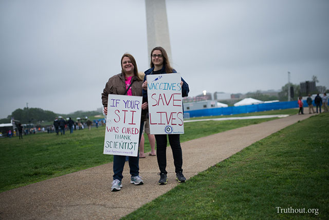 Athena and Maria from New York were early to the march - holding homemade signs that expressly expressed why saving science was worth it - it's good for your health. (Photo: Zach Roberts)