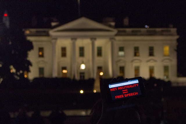 An activist raises a sign on a smartphone to protest the proposed stripping of Net Neutrality in Washington, DC, November 6, 2014. (Photo: Joseph Gruber)