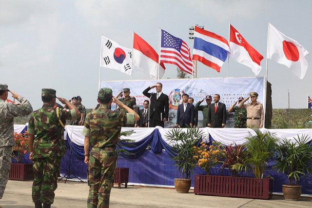 Service members from countries participating in Cobra Gold 2010 salute during the exercise's opening ceremony at Utapao Naval Air Base in Thailand Feb. 1, 2010. At least 45 less-than-democratic nations and territories host scores of US military bases.