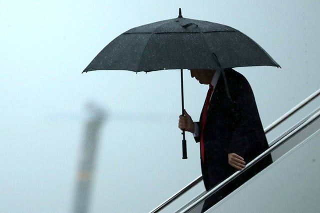 President Donald Trump uses an umbrella after stepping out of Air Force One July 28, 2017 in Joint Base Andrews, Maryland. (Photo by Chip Somodevilla / Getty Images)