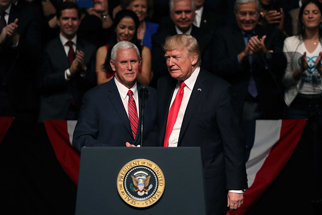 President Donald Trump (right) is introduced by Vice President Mike Pence at the Manuel Artime Theater in the Little Havana neighborhood on June 16, 2017 in Miami, Florida. (Photo: Joe Raedle / Getty Images)