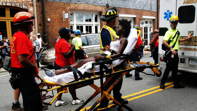 An injured counter-protester is wheeled into an ambulance during a white supremacist rally in Charlottesville, Virginia, August 12, 2017. (Image: Democracy Now)