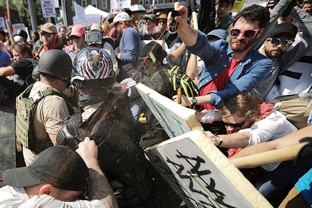 White nationalists, neo-Nazis and members of the 'alt-right' exchange vollies of pepper spray with counter-protesters as they enter Emancipation Park during the 'Unite the Right' rally August 12, 2017 in Charlottesville, Virginia. (Photo: Chip Somodevilla / Getty Images)