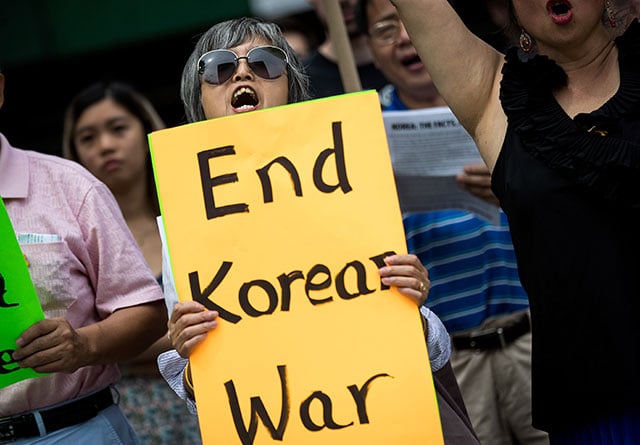 Activists, including several Korean-Americans, rally against possible U.S. military action and sanctions against North Korea, across the street from the United Nations headquarters, August 14, 2017 in New York City. The group called for President Trump to tone down his 'pro-war rhetoric' and to engage in diplomatic talks with North Korea. (Photo: Drew Angerer / Getty Images)