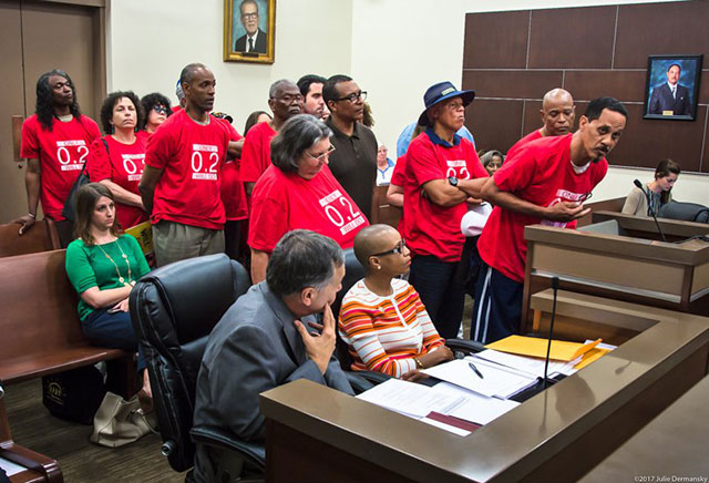 Members of Concerned Citizens of St. John at a parish council meeting in LaPlace, Louisiana, on March 28 wearing red t-shirts printed with Only 0.2 will do, emphasizing their point that chloroprene emissions should not exceed the EPA's recommendation.