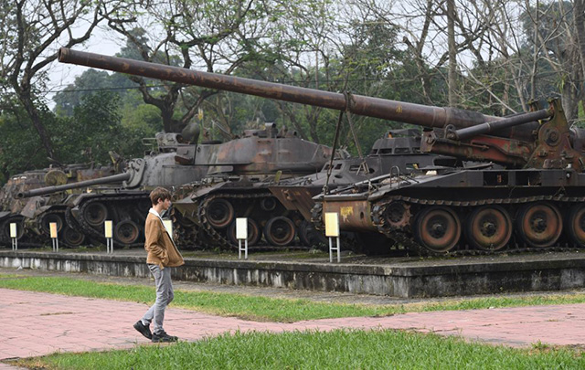 In this picture taken on January 17, 2018, a tourist looks at US-made tanks captured during the war, on display at the Revolutionary Museum in Hue. (Photo: Hoang Dinh Nam / AFP / Getty Images)