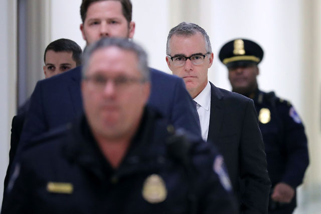 Federal Bureau of Investigation Deputy Director Andrew McCabe (C) is escorted by US Capitol Police before a meeting with members of the Oversight and Government Reform and Judiciary committees in the Rayburn House Office Building, December 21, 2017 in Washington, DC. (Photo: Chip Somodevilla / Getty Images)