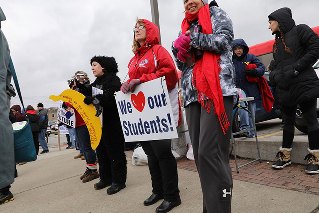 West Virginia teachers, students and supporters hold signs as they continue their strike on March 2, 2018, in Morgantown, West Virginia. (Photo: Spencer Platt / Getty Images)