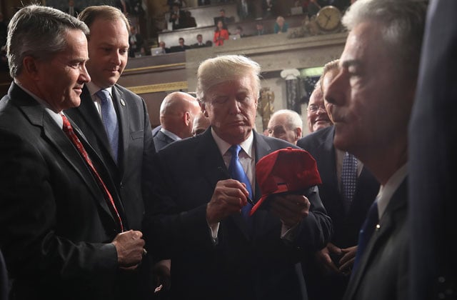President Donald J. Trump signs a hat after finishing the State of the Union address in the chamber of the US House of Representatives January 30, 2018, in Washington, DC. (Photo: Win McNamee / Getty Images)