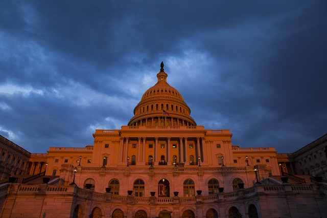 The U.S. Capitol is bathed in the light of the sun setting over the National Mall in Washington, USA on March 7, 2018. (Photo by Samuel Corum/Anadolu Agency/Getty Images)